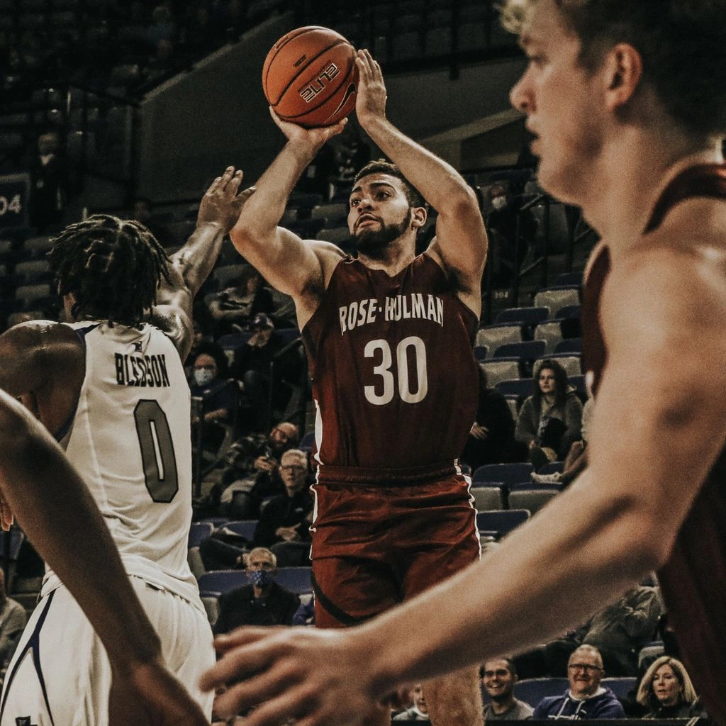 Big East guard driving to the rim under arena lights